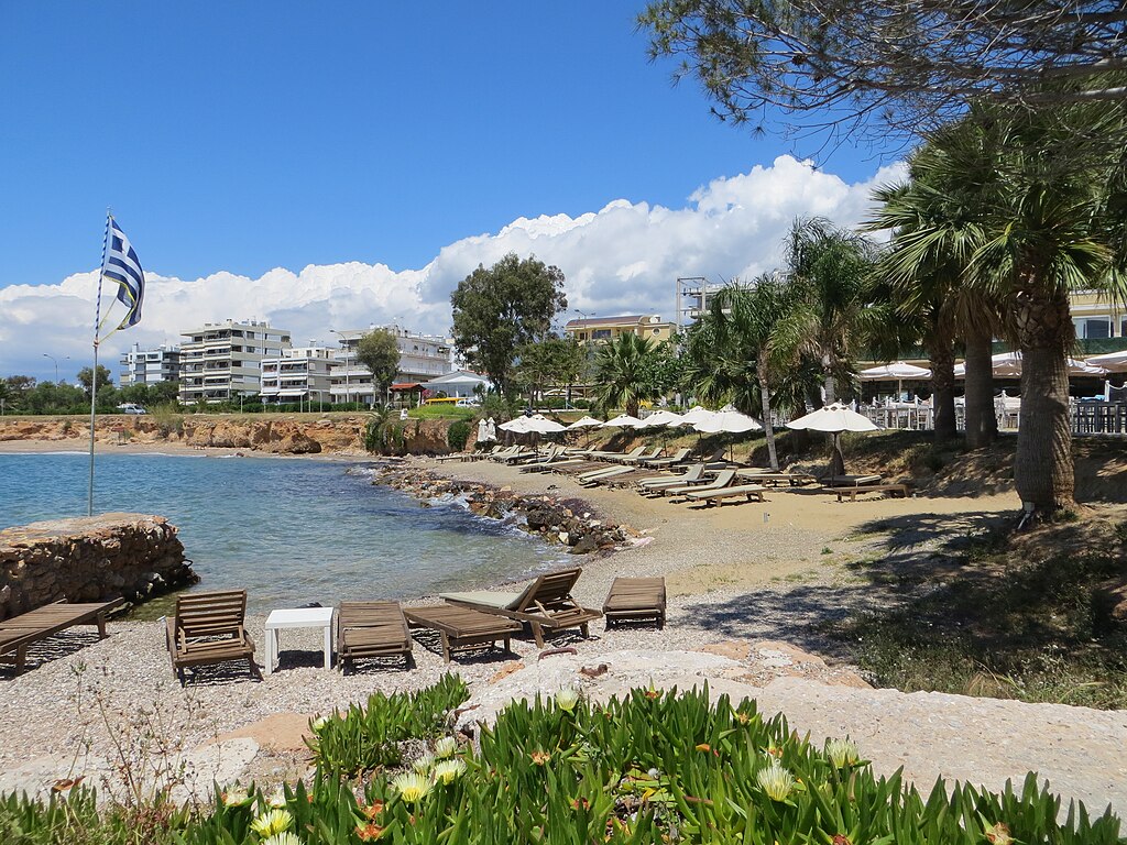 Voula Beach in Attica, featuring a sandy shoreline with calm water conditions, certified with Blue Flag status for environmental quality