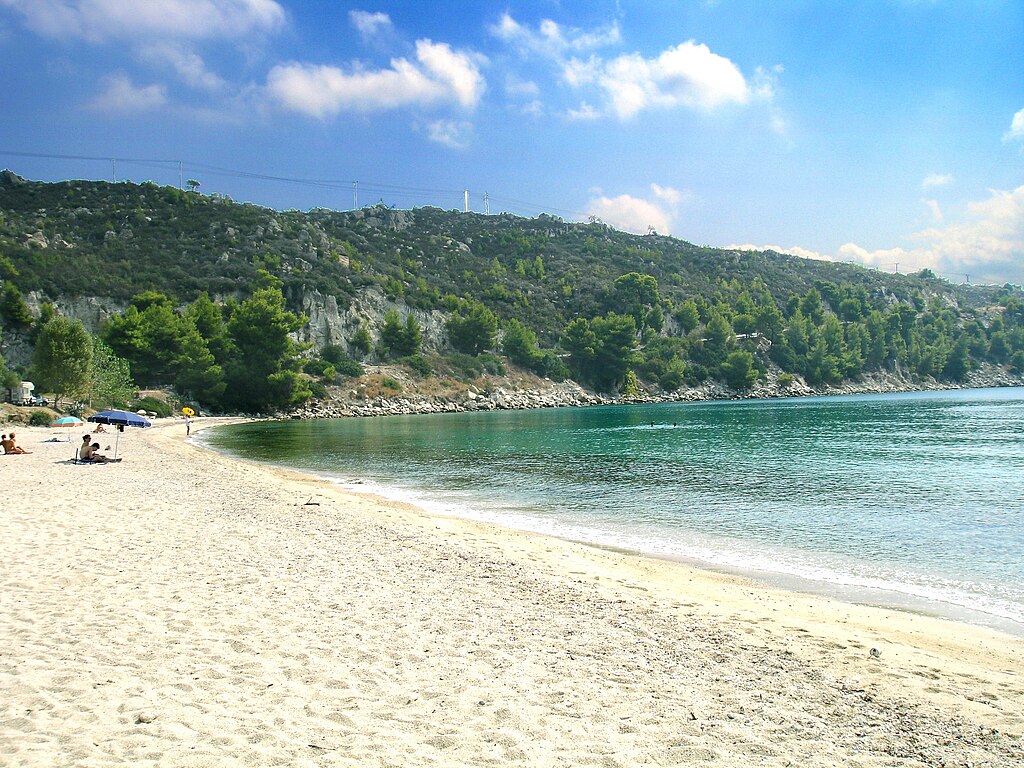 Agios Ioannis Beach in Chalkidiki, featuring a sandy shoreline with calm water conditions
