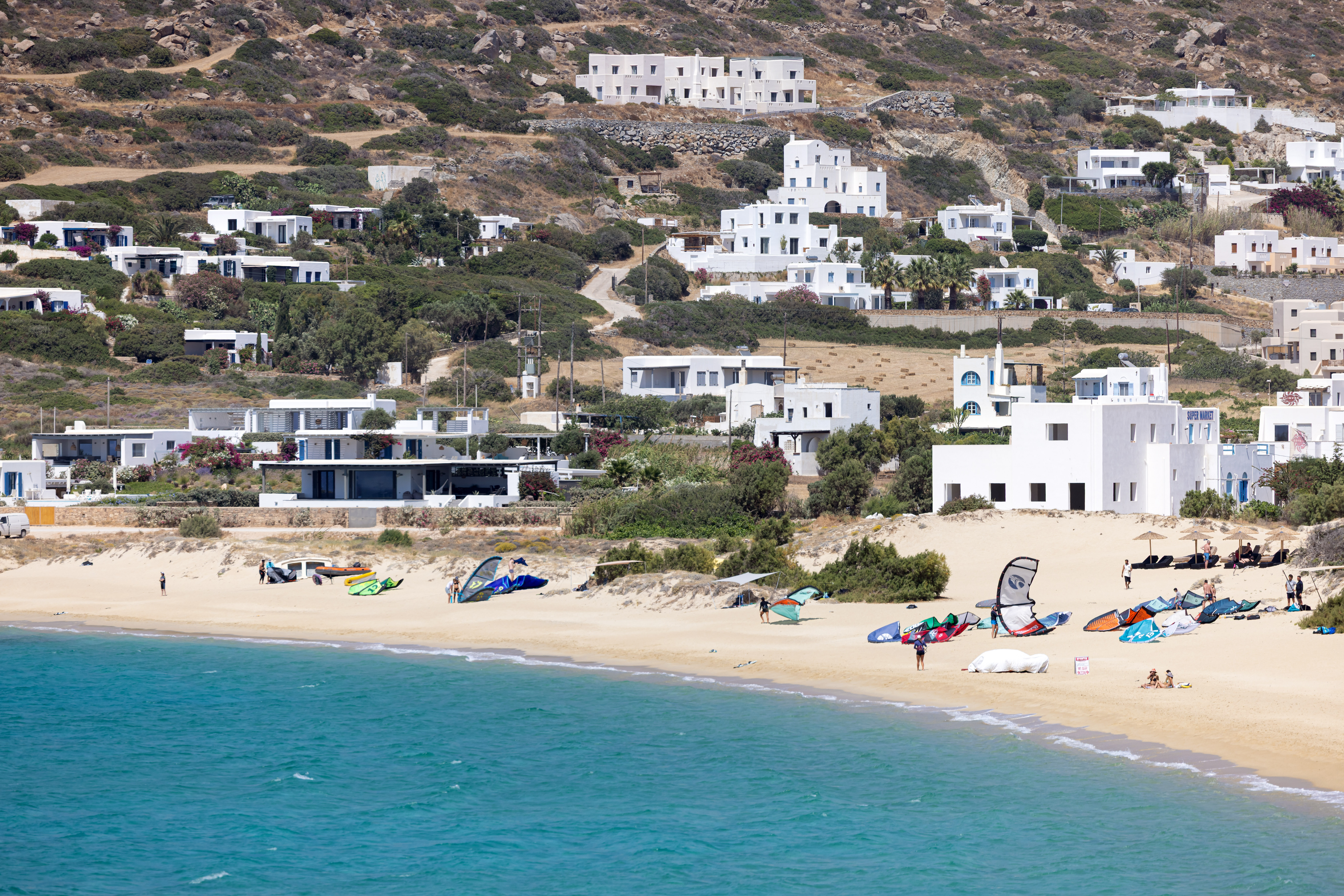 Mikri Vigla beach in Naxos, featuring a sandy shoreline with moderate water conditions