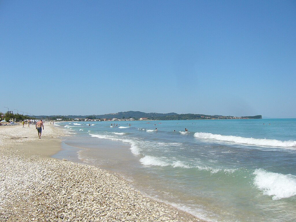 Acharavi Beach in Corfu, featuring a mixed shoreline with calm water conditions