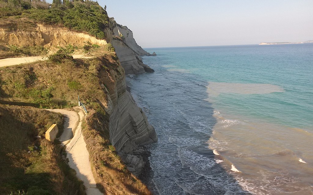 Loggas Beach in Corfu, featuring a mixed shoreline with wavy water conditions