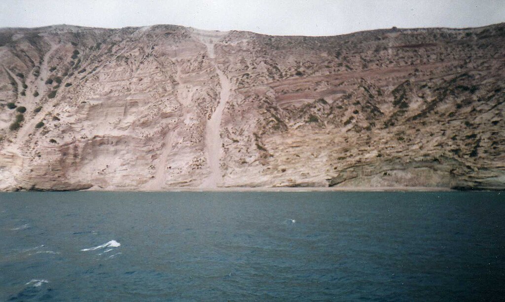 Gerakas Beach in Milos, featuring a sandy shoreline with calm water conditions