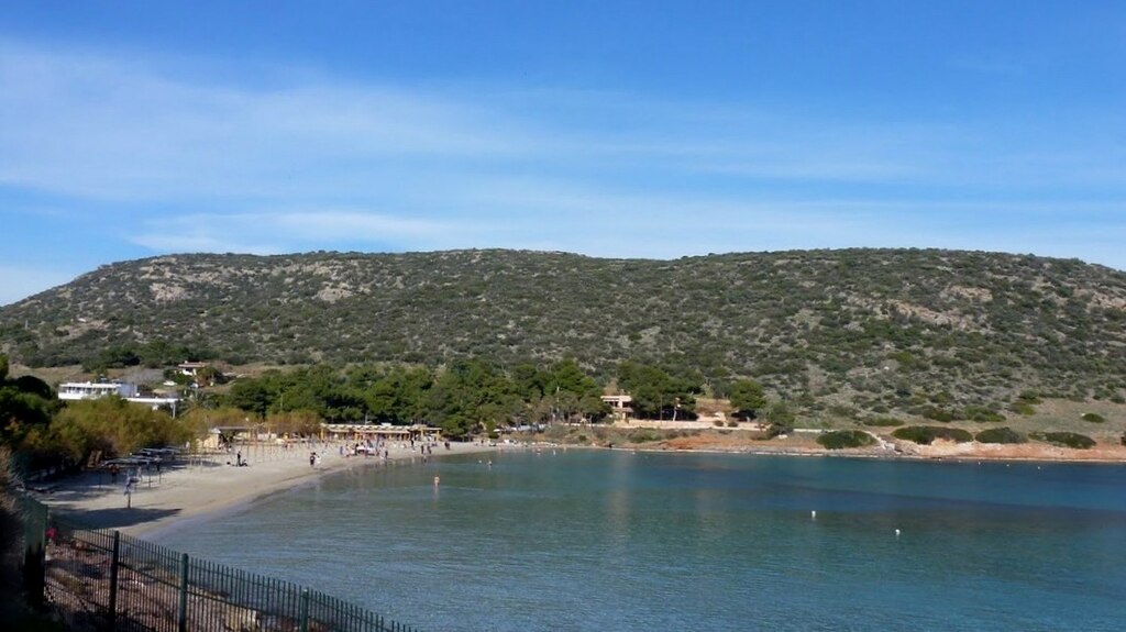 Avlaki Beach in Attica, featuring a sandy shoreline with calm water conditions, certified with Blue Flag status for environmental quality