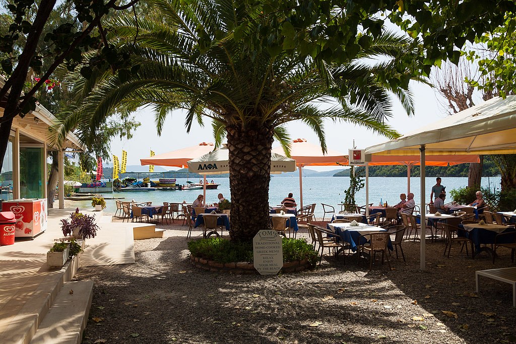 Nidri Beach in Lefkada, featuring a mixed shoreline with calm water conditions