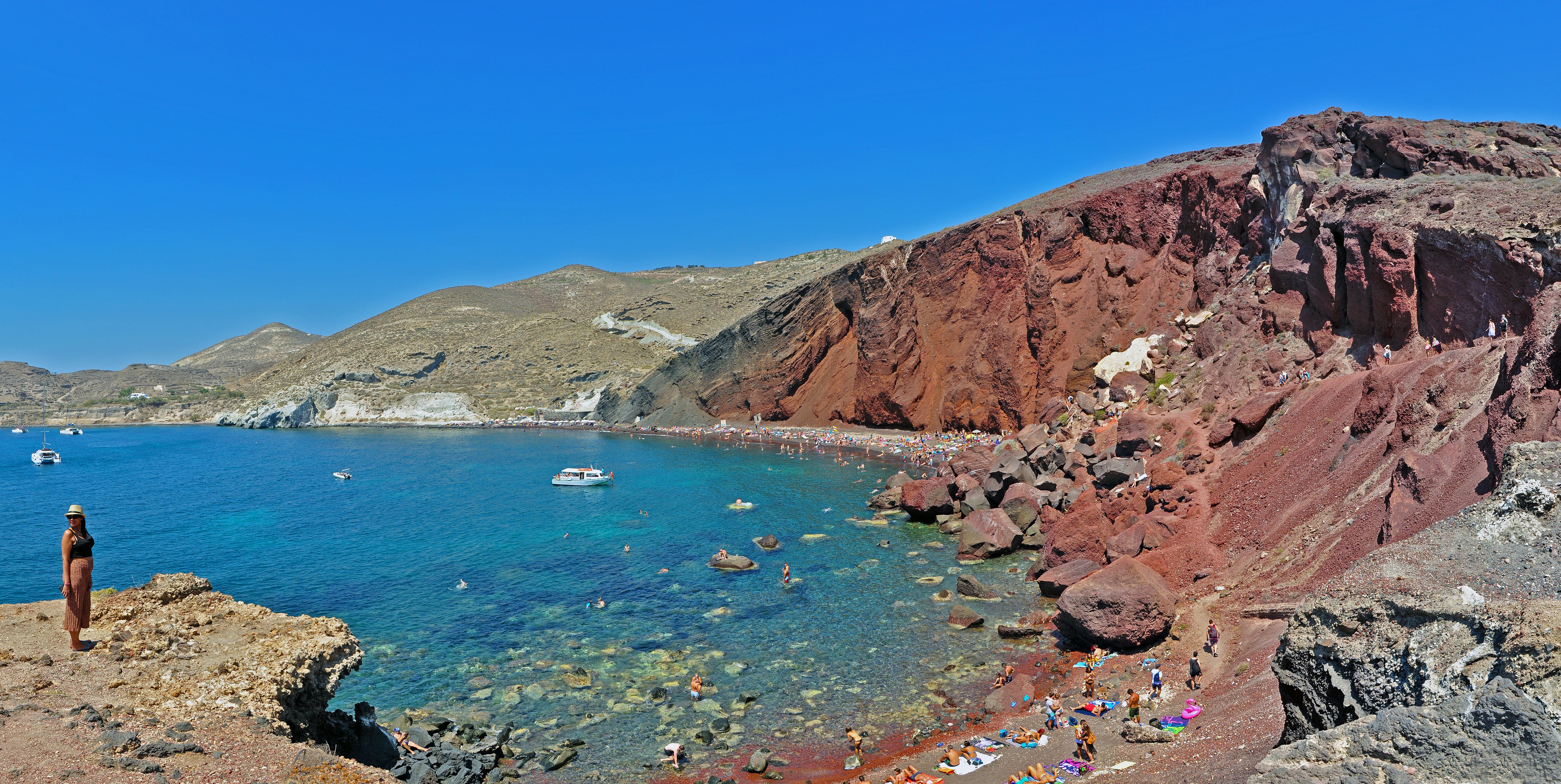 Red Beach in Santorini, featuring a sandy shoreline with calm water conditions