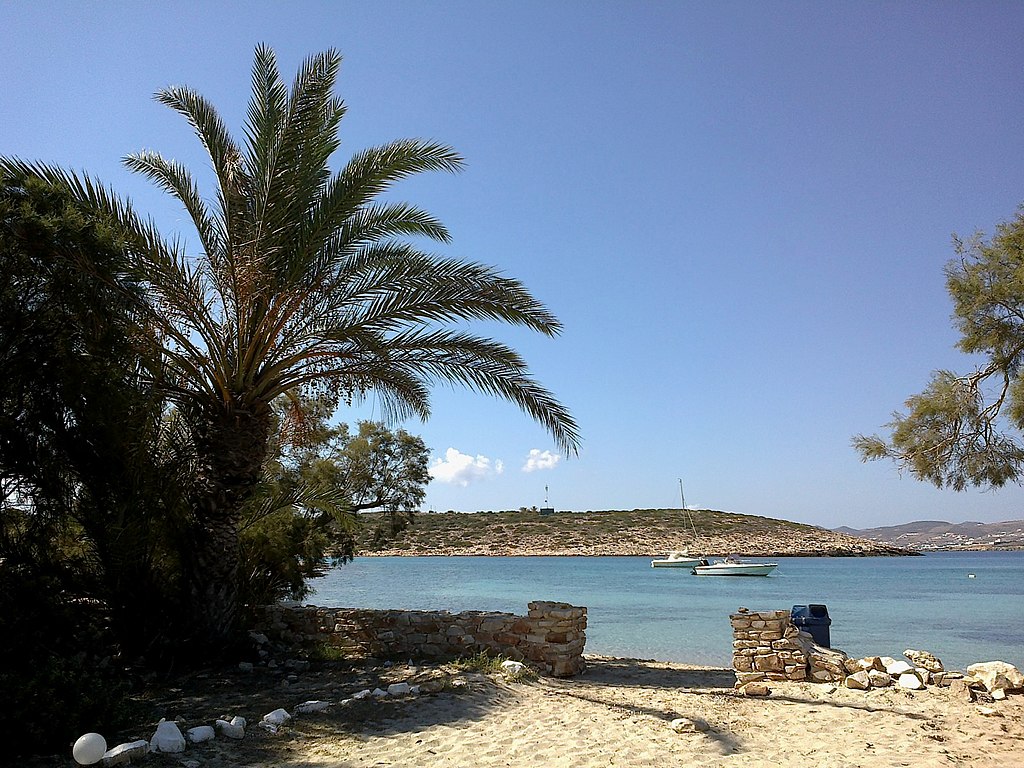 Agia Irini Beach in Paros, featuring a sandy shoreline with calm water conditions