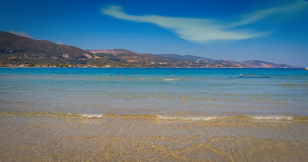 Alykanas Beach in Zakynthos, featuring a sandy shoreline with calm water conditions, certified with Blue Flag status for environmental quality