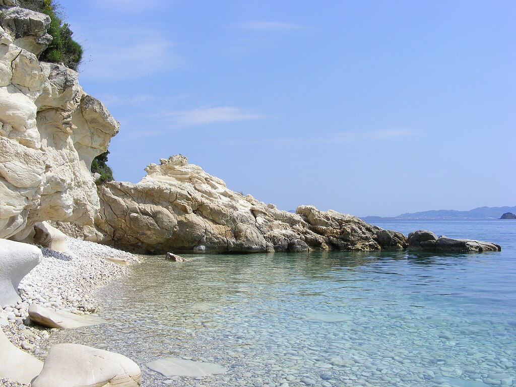 Marathias Beach in Zakynthos, featuring a pebbly shoreline with calm water conditions