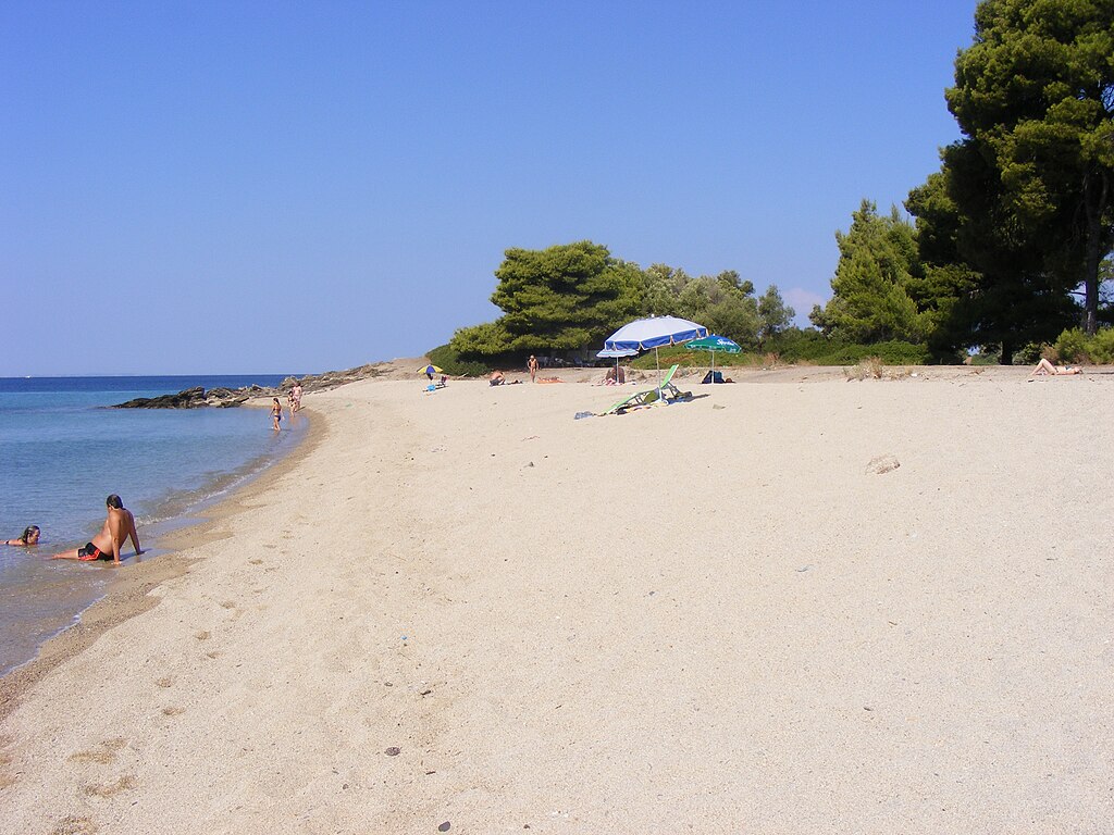 Lagomandra Beach in Chalkidiki, featuring a sandy shoreline with calm water conditions, certified with Blue Flag status for environmental quality