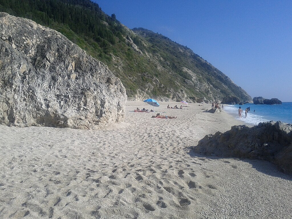 Megali Petra Beach in Lefkada, featuring a mixed shoreline with wavy water conditions